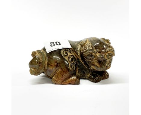 A Chinese carved jade/hardstone figure of a mythical animal with lotus shaped tail, L. 12.5cm, H. 6cm.