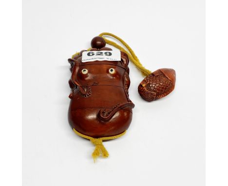 A carved fruitwood Inro in the shape of a squid, L. 10cm with glass eyes and fish shaped Netsuke, L. 4.5cm.