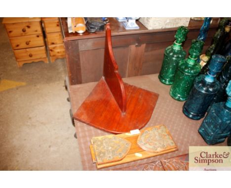 A brass mounted book slide and a corner shelf 