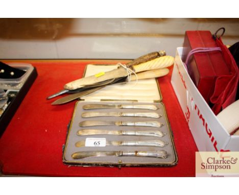 A cased set of six silver handled butter knives; three carving knives; a meat skewer and fork