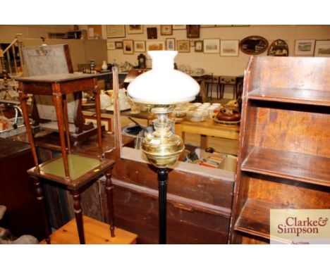 An oil lamp converted to electricity with milk glass shade