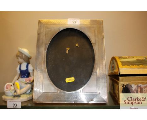 A silver photo frame with engine turned decoration