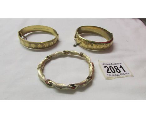 An 18ct gold plated bangle together with a rolled gold bangle and a silver bangle, mostly 1970/80's.