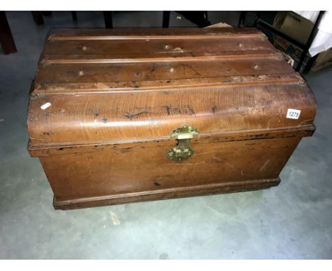 A large vintage metal steamer trunk