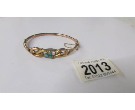An Edwardian gold bangle set turquoise stones.