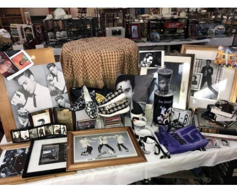 A large collection of Elvis memorabilia including Clock, lamp, pictures, mugs, shower curtain, cd's, tape cassettes, handbag,