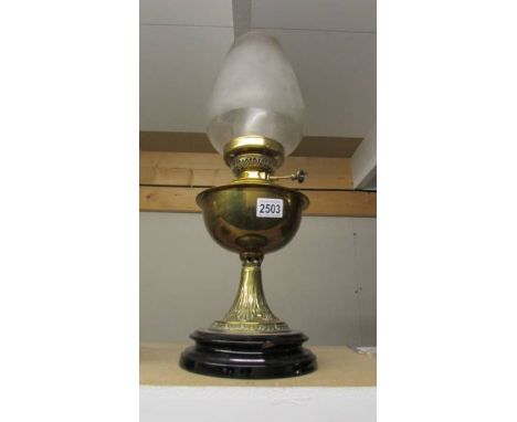 A brass oil lamp on pot base complete with shade and chimney. (Collect only)
