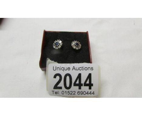 A pair of 18ct gold diamond and sapphire earrings.