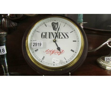 A Guiness advertising wall clock.