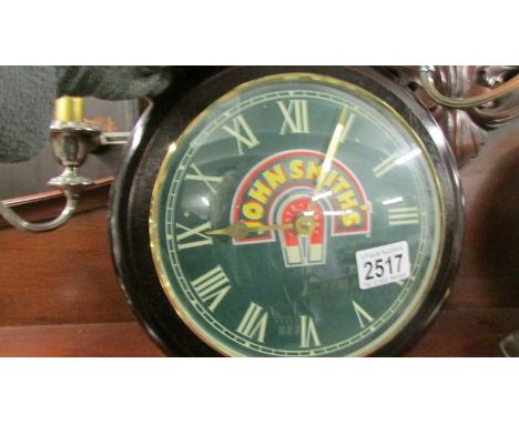 A John Smith's advertising wall clock.