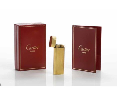 CARTIER GOLD PLATED CIGARETTE LIGHTER
with machine turned decoration, stamped Cartier, Paris, numbered F18447 original box wi