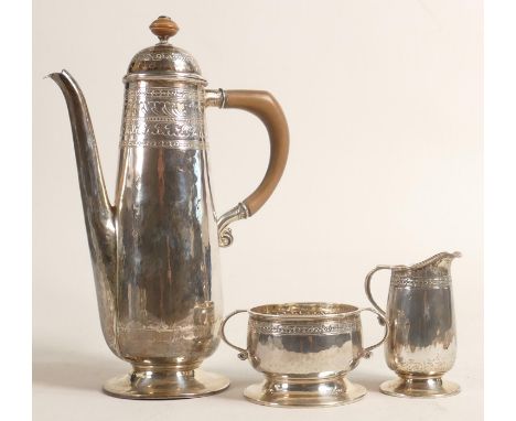 Silver coffee pot of slender form and Arts &amp; Crafts style, together with matching sugar bowl and cream jug.  Maker mark W