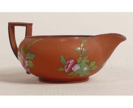A Wedgwood Rosso Antico Egyptian shaped jug. Circa 1820. Glazed interior. Hand painted enamel decoration with Chinese flowers