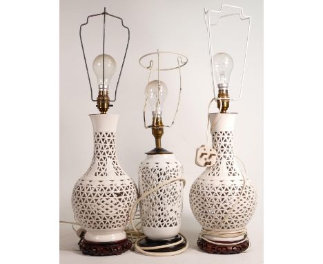 Three Chinese reticulated Creamware lamp bases, height of largest 39.5cm, one of pair with damaged panel. (3) 