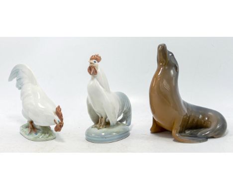 Royal Copenhagen models of cockerels 1127 and 067 and a seal 1441, h.12.5cm. (3) 