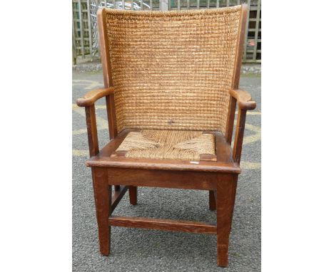 Oak framed Orkney chair with woven and stitched curved rush back, open armrests and woven seagrass seat panel, set on square 