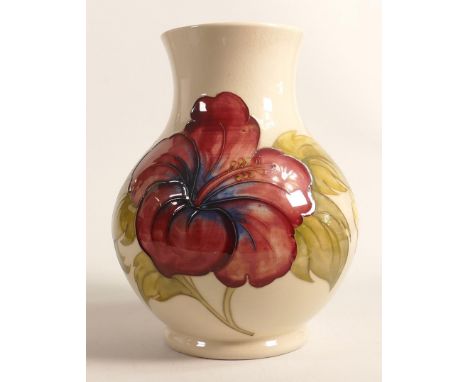 Walter Moorcroft vase decorated in the hibiscus design on cream ground, h.24.5cm, good condition with some light crazing. 