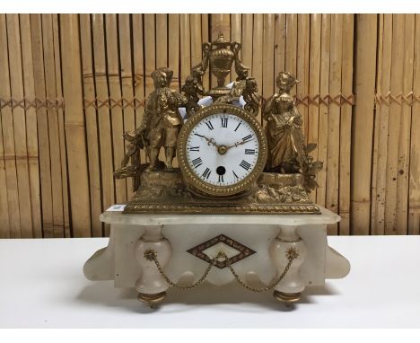 FRENCH MANTEL CLOCK CIRCA 1900 DRUM CLOCK MOVEMENT AND CASE MOUNTED ON ONYX BASE  AND MALE AND FEMALE FIGURES TO EITHER SIDE.