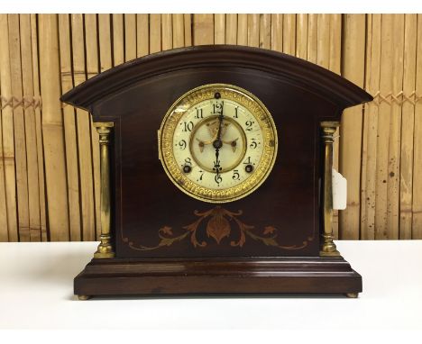 MAHOGANY CASED MANTEL CLOCK WITH DECORATIVE INLAYS, BRASS PILLARS TO FRONT, PENDULUM MOVEMENT WITH VISIBLE ESCAPEMENT. ENAMEL