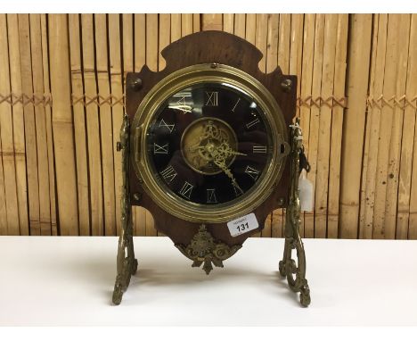 UNUSUAL VICTORIAN MANTEL CLOCK WITH SCROLLED BRASS SUPPORT BRACKETS, MAHOGANY BACK PLATE. VISIBLE ESCAPEMENT AND MOVEMENT
