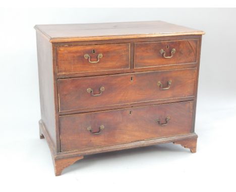 George III mahogany chest of drawers, the moulded rectangular top above an arrangement of two short and two long drawers, on 