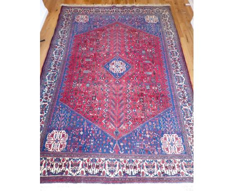 Qashqai carpet, with geometric and stylised floral design, over ruby and indigo ground, 320 x 212cm w