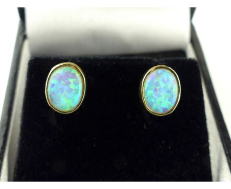 Pair of yellow gold and opal collett set stud earrings 