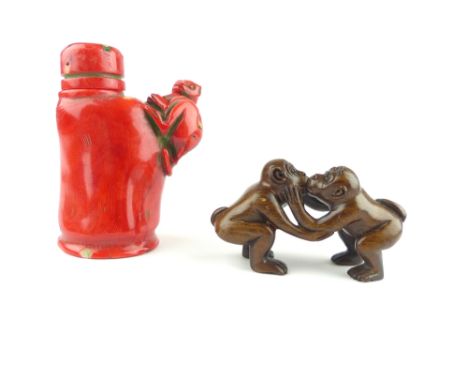 Chinese ceramic snuff bottle, moulded with monkey to side, and a carved wooden figure of two monkeys kissing, 