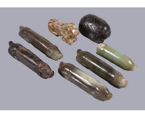 Five Chinese jade Archaistic 'sway-back' pigs, in brown, celadon and variegated colours, between 10cm and 7cm long and two ot
