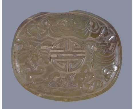 A Chinese celadon jade oval plaque, probably 19th century, 8.5cm wide x 7.2cm high