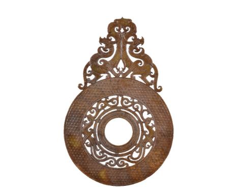 A Chinese Han-style reticulated brown and yellow jade disc, bi, cut with a central openwork of phoenix within a raised field 