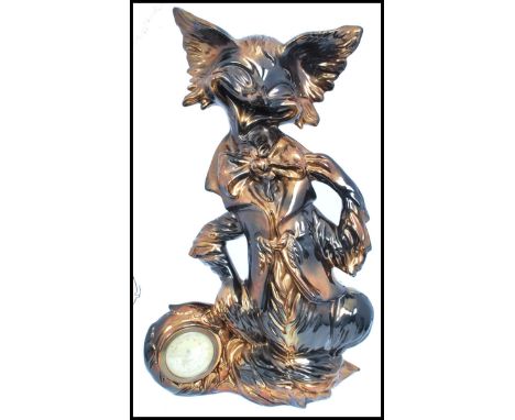 A vintage 20th century retro ceramic clock in the form of a fox having an inset Mercedes clock to tail. Measures 42.5 cm high