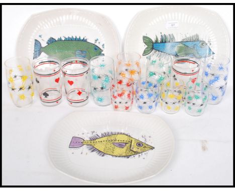 A good collection of mid 20th century drinking glasses some decorated with playing cards together with three retro dinner pla