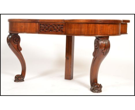 A 19th century Victorian console table of shaped form being raised on carved bulbous supports with serpentine shaped top and 