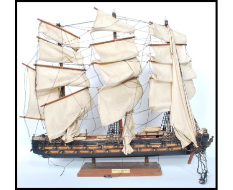A vintage 20th century&nbsp; scratch built model of a three masted galleon with sails and rigging. Raised on stand