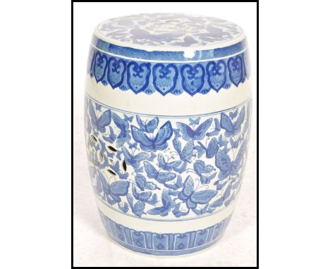 A 20th century Chinese blue and white ceramic barrel stool - stand. Barrel form with pierced top having blue and white decora