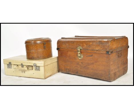 A group of early 20th century vintage luggage to include a vintage grained tin trunk with lock to front, a vellium suitcase a