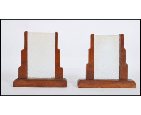 A pair of 1930's Art Deco oak photograph - picture frames. Each of odeon shaped design with mottled glass panel centres