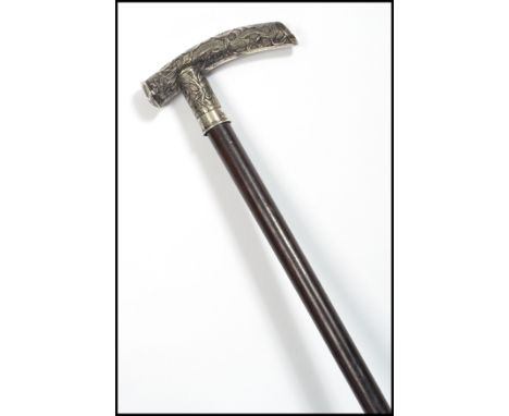 A 19th century Chinese silver walking stick cane. The tapering ebony shaft with silver dragon handle with character marks. Ch