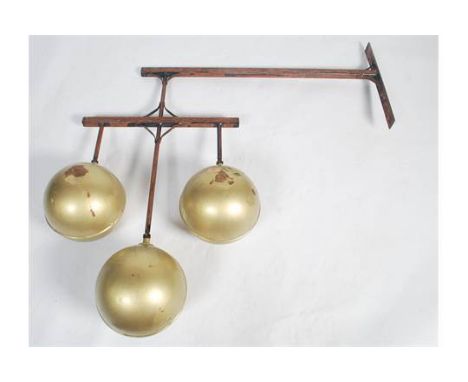 A 20th century original shop point advertising pawn balls - Pawn Shop Sign. Raised on the exterior wall bracket having three 
