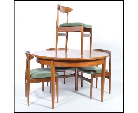 G-Plan - A retro 1960's teak wood extending dining table of round form raised on tapering legs having a fitted frieze togethe