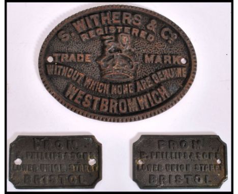 A group of three vintage early 20th century Industrial cast iron metal machine name plaques to include a pair of Phillips&amp