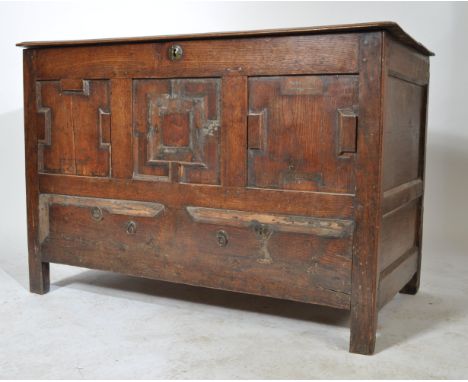 An 18th century carved oak faux mule chest coffer. Being raised on stile legs with geometric panel moulded facia over faux dr
