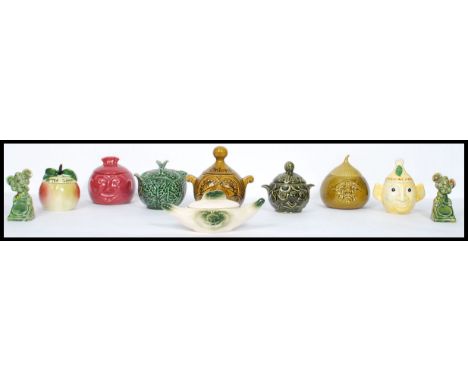 A collection of vintage 20th century ceramic condiment jars with faces to include apple sauce, mint, cabbage, onion etc. Vari