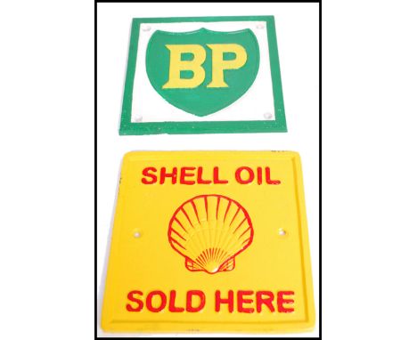 A pair of square vintage style cast metal point of sale advertising garage wall plaques for Shell Oil and BP / British Petrol