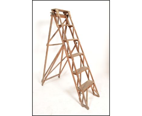 An early 20th century wooden trellis - lattice worked Industrial step ladder. Ideal as conversion to bookcase / display shelf