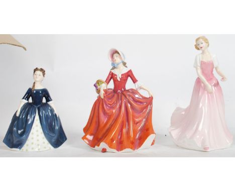 A group of vintage ceramic figures to include a Royal Doulton Debbie HN2385, Julie HN3878 and Autumn Stroll. Highest measures