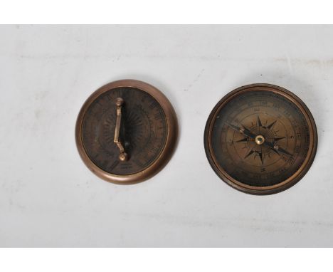 An unusual 20th century Gilbert Sundial - brass pocked cased sundial and compass being of roundel form with dials to borders 