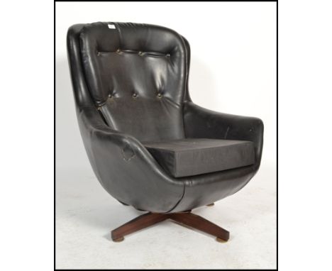 A vintage Scandinavian Parker Knoll black faux&nbsp;leather swivel button back pod armchair with five spoke base and shaped b