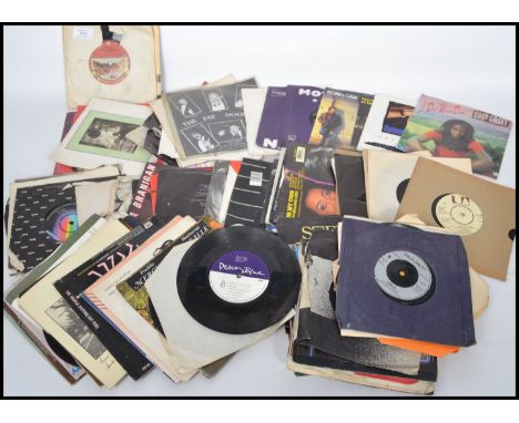 A collection of vintage vinyl record 45rpm 7" singles dating from the 1960s to include an Elvis EP, The Rolling Stones, Juluk